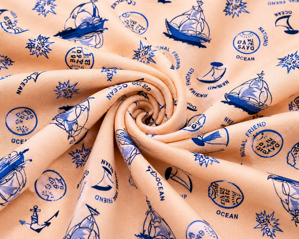 Single jersey knit with a nautical print on a peach background