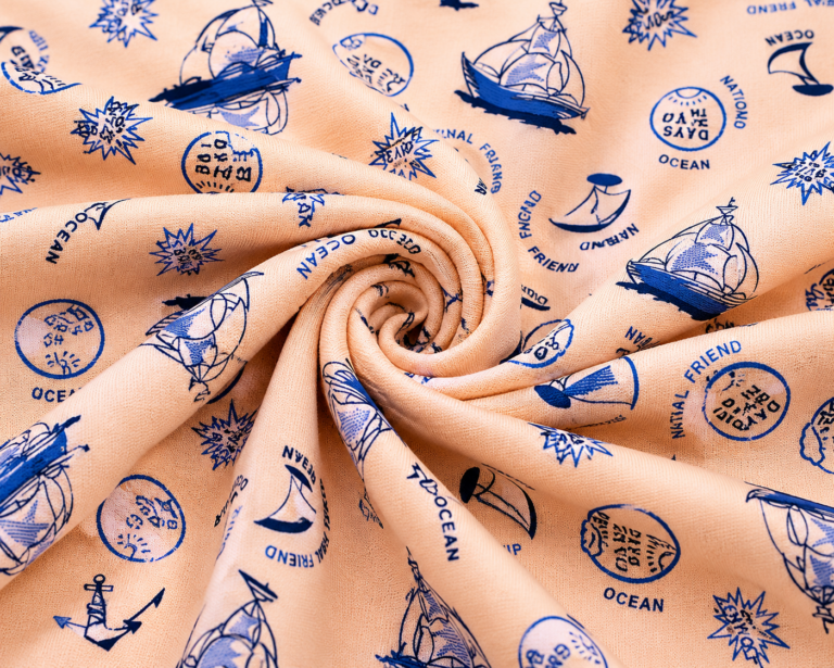 Single jersey knit with a nautical print on a peach background